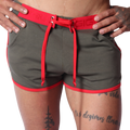 Front view of Gigo Nafts green jersey shorts with red trim, lace-up waistband, and drawstring detail.