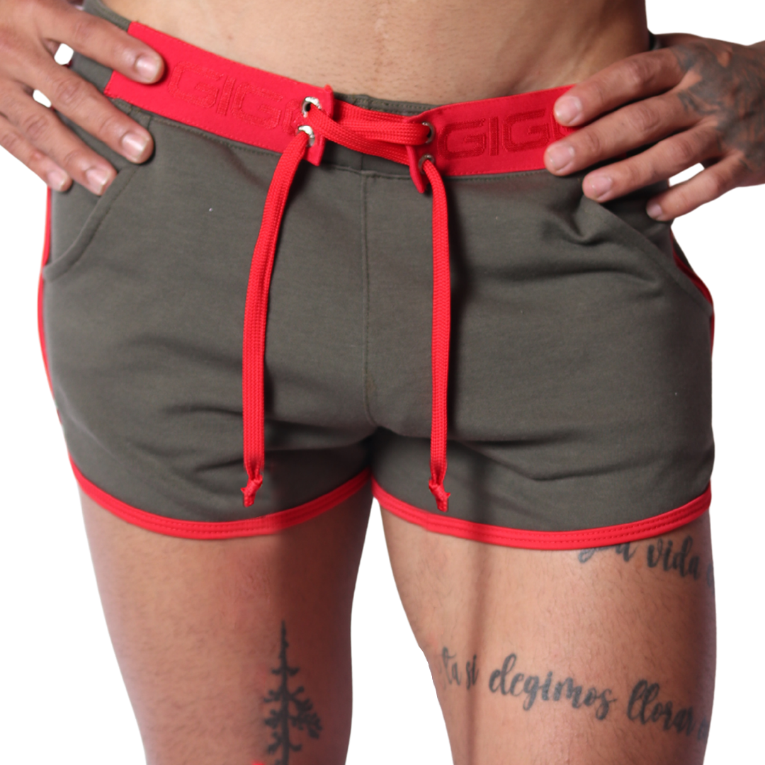 Front view of Gigo Nafts green jersey shorts with red trim, lace-up waistband, and drawstring detail.