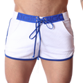 Front view of Gigo Nafts white jersey shorts with blue contrast trim, logo waistband, and lace-up drawstring closure.
