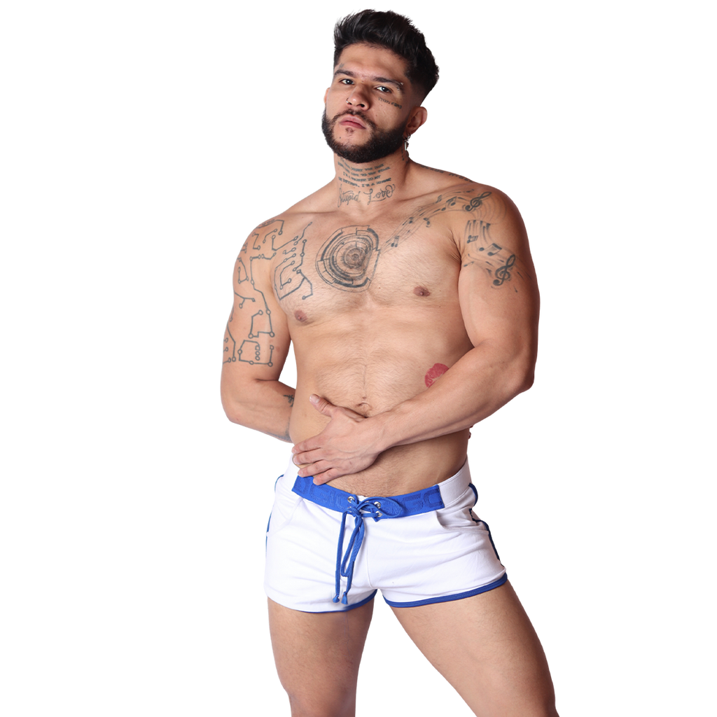Front view of Gigo Nafts white fabric shorts with blue drawstring waist and trim, modeled by a tattooed man.