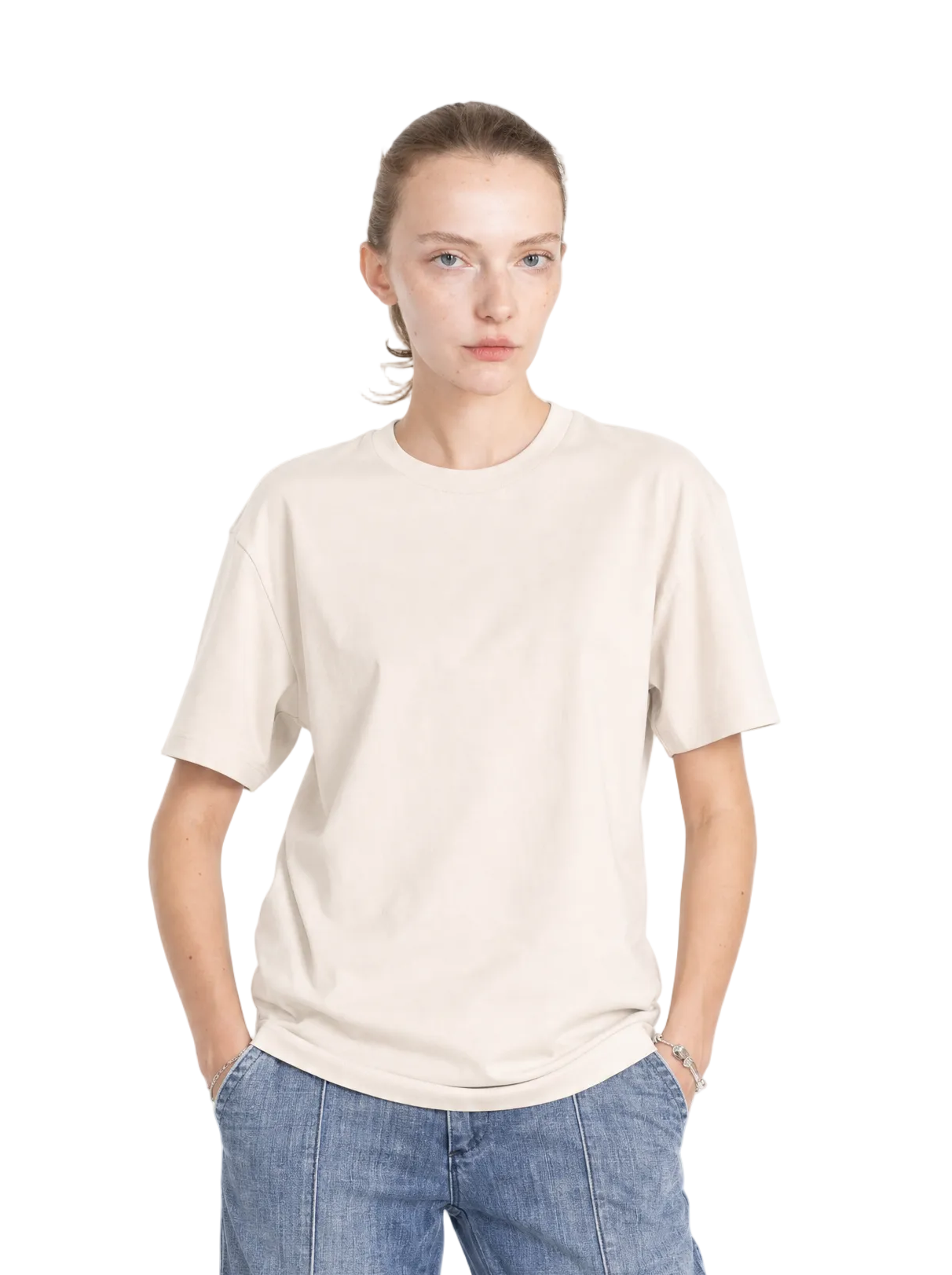 Model wears a cream-colored, relaxed-fit cotton core tee with a classic crew neck and short sleeves.