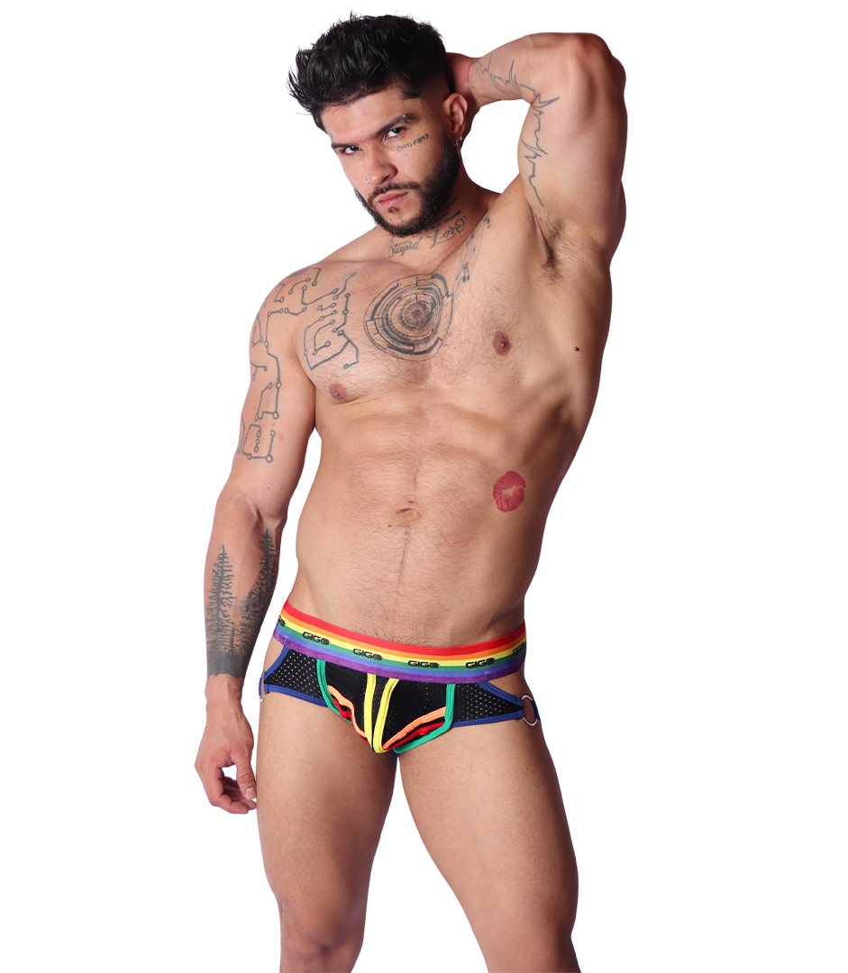 Front view of Gigo Pride jockstrap in black mesh fabric with rainbow trim and metal side rings on a muscular model.