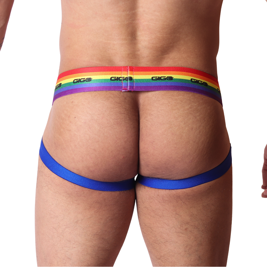 Back view of Gigo Pride jockstrap with elastic rainbow waistband and blue leg straps on a black background.