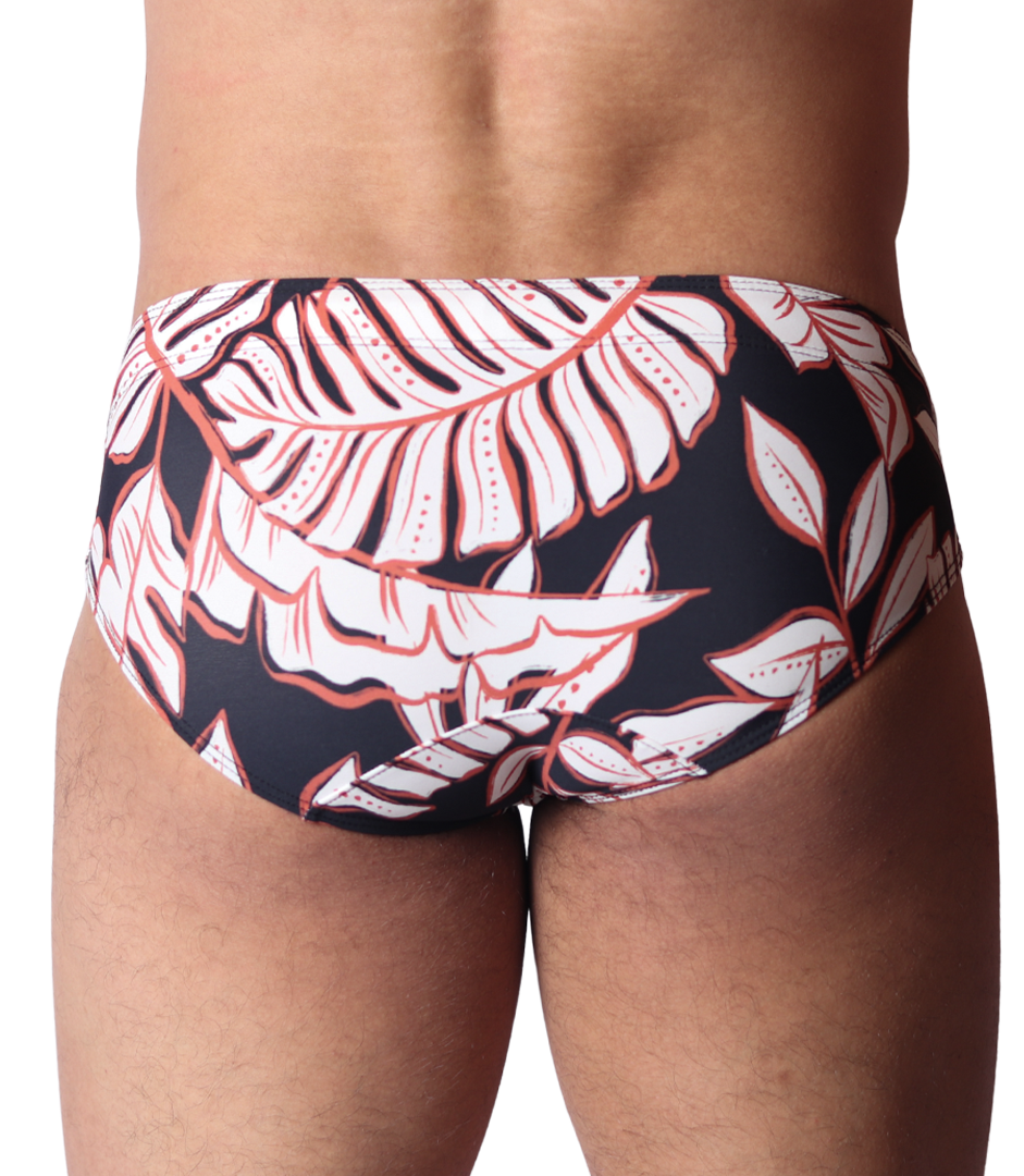 Back view of Gigo Prisma black swim brief featuring a white and red tropical leaf print on smooth stretch fabric.