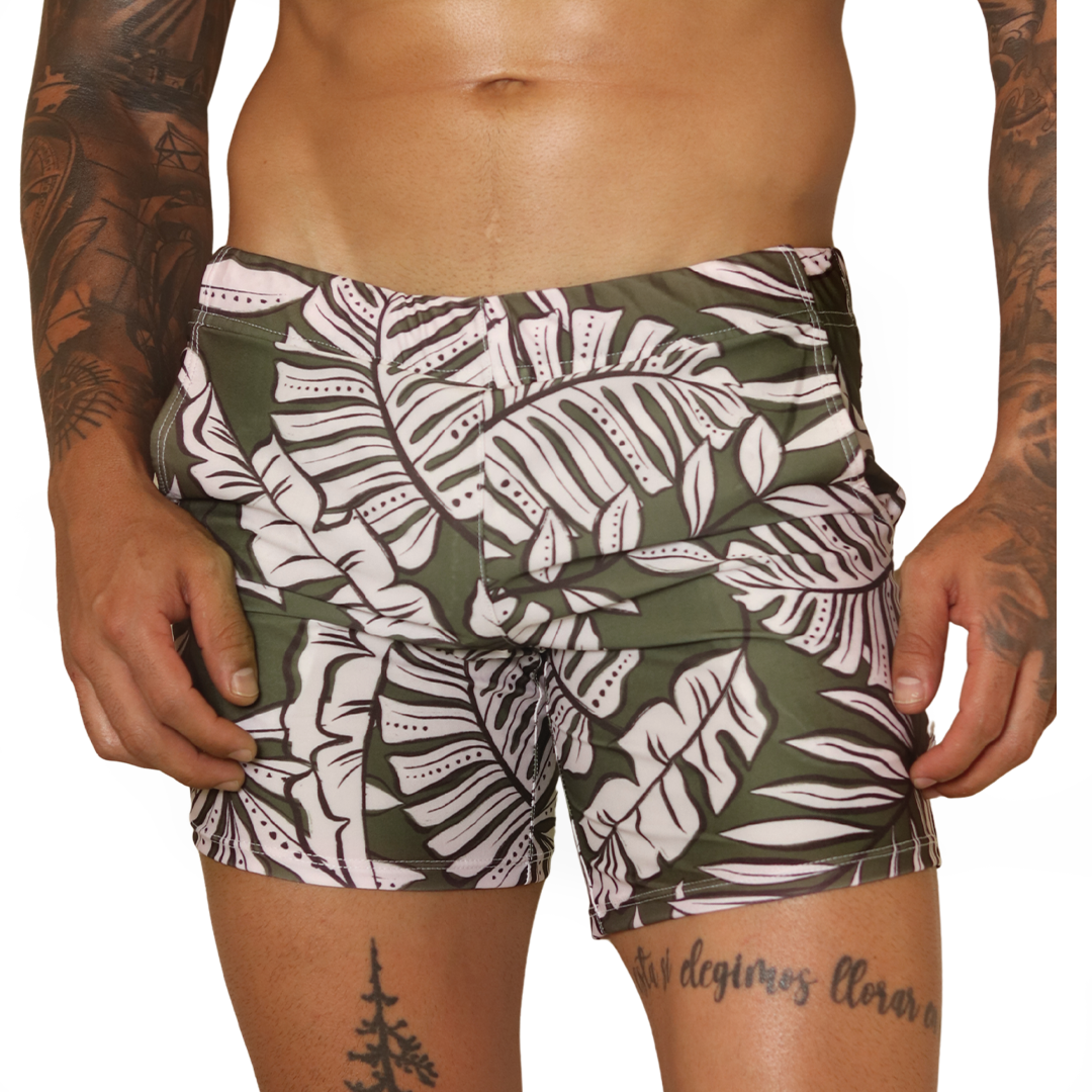 Gigo Prisma green tropical leaf print beachwear shorts. Front view of fabric fitted swim trunk style.