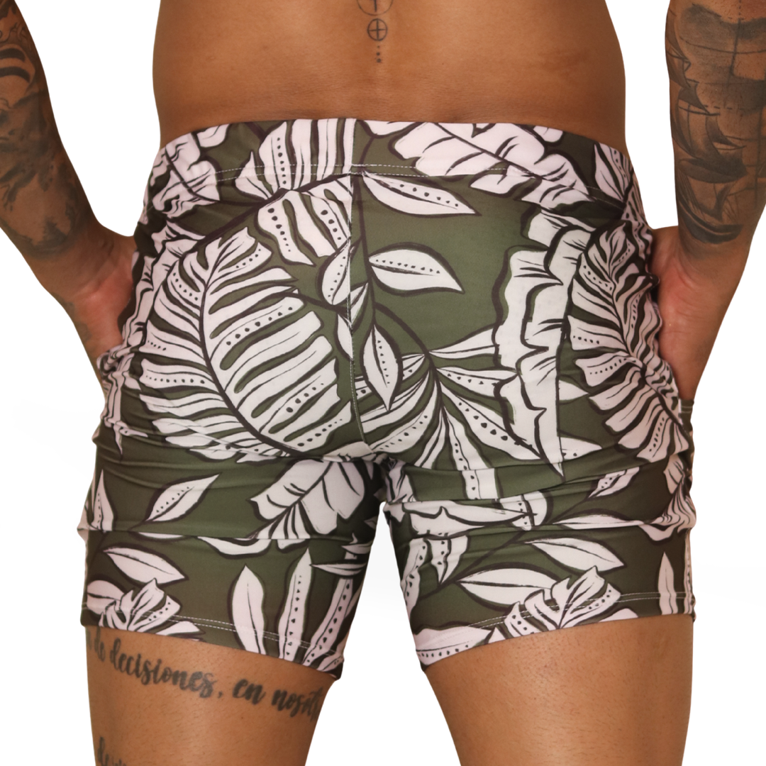 Back view of Gigo Prisma green leaf print stretch fabric BEACHWEAR shorts with white foliage patterns.