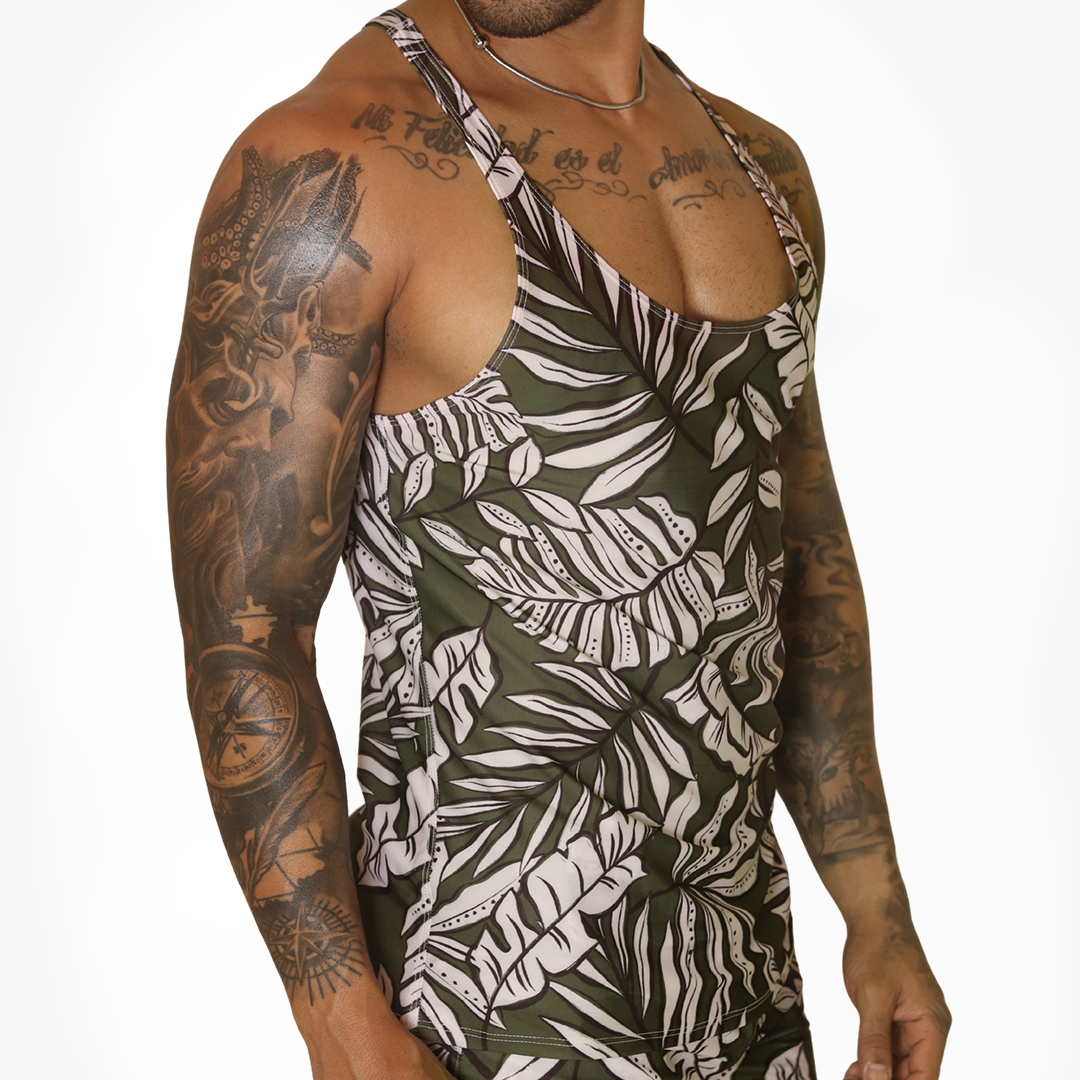 Gigo Prisma green tropical leaf print tank top, fitted athletic fabric, side view on tattooed model.