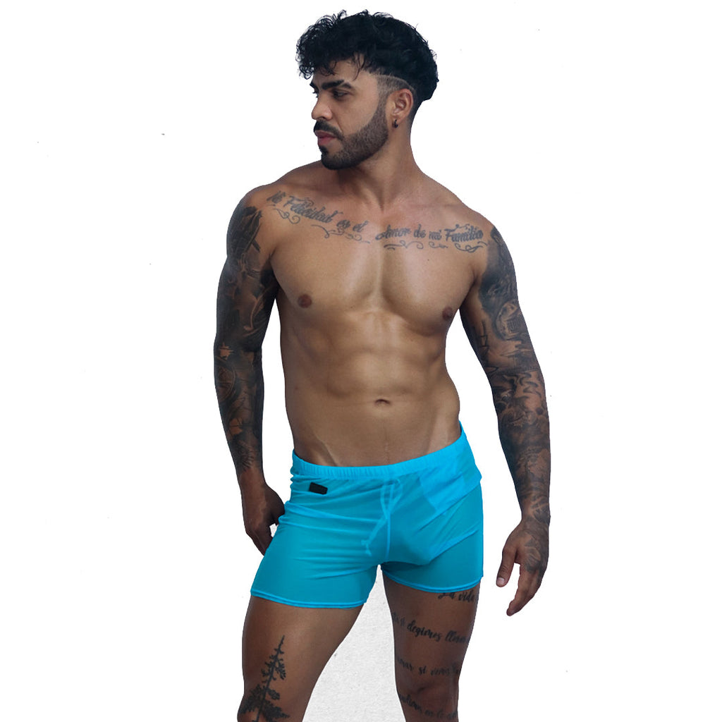 Gigo spectrum blue mesh hot shorts, front view on a tattooed model, showing fitted sheer fabric and elastic waistband.