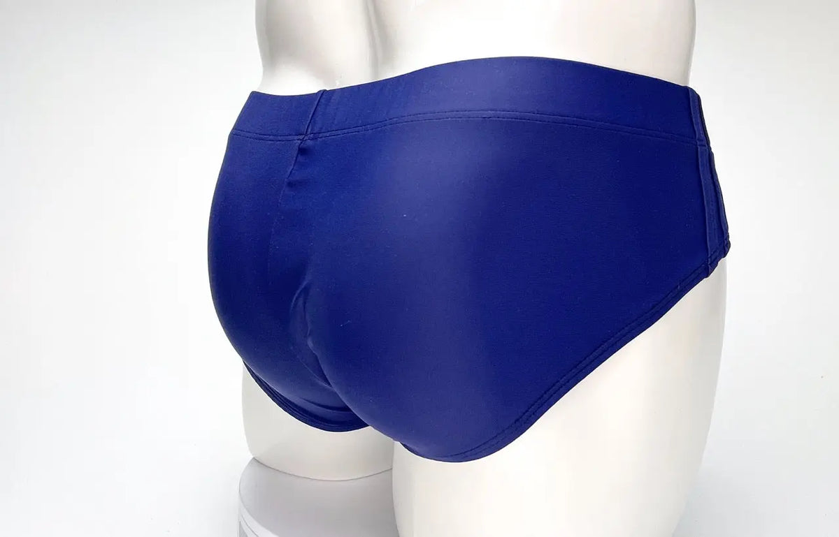 Blue briefs on a white mannequin against a white background.