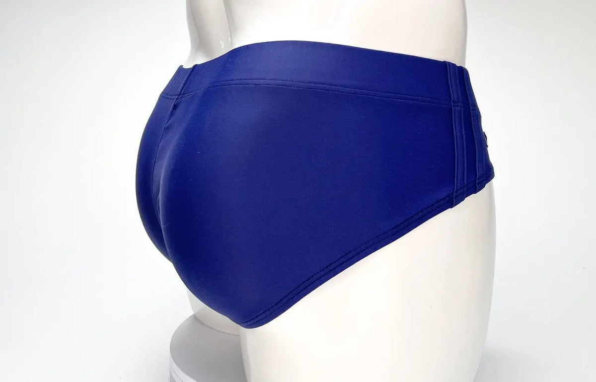 Blue briefs on a white mannequin against a white background.