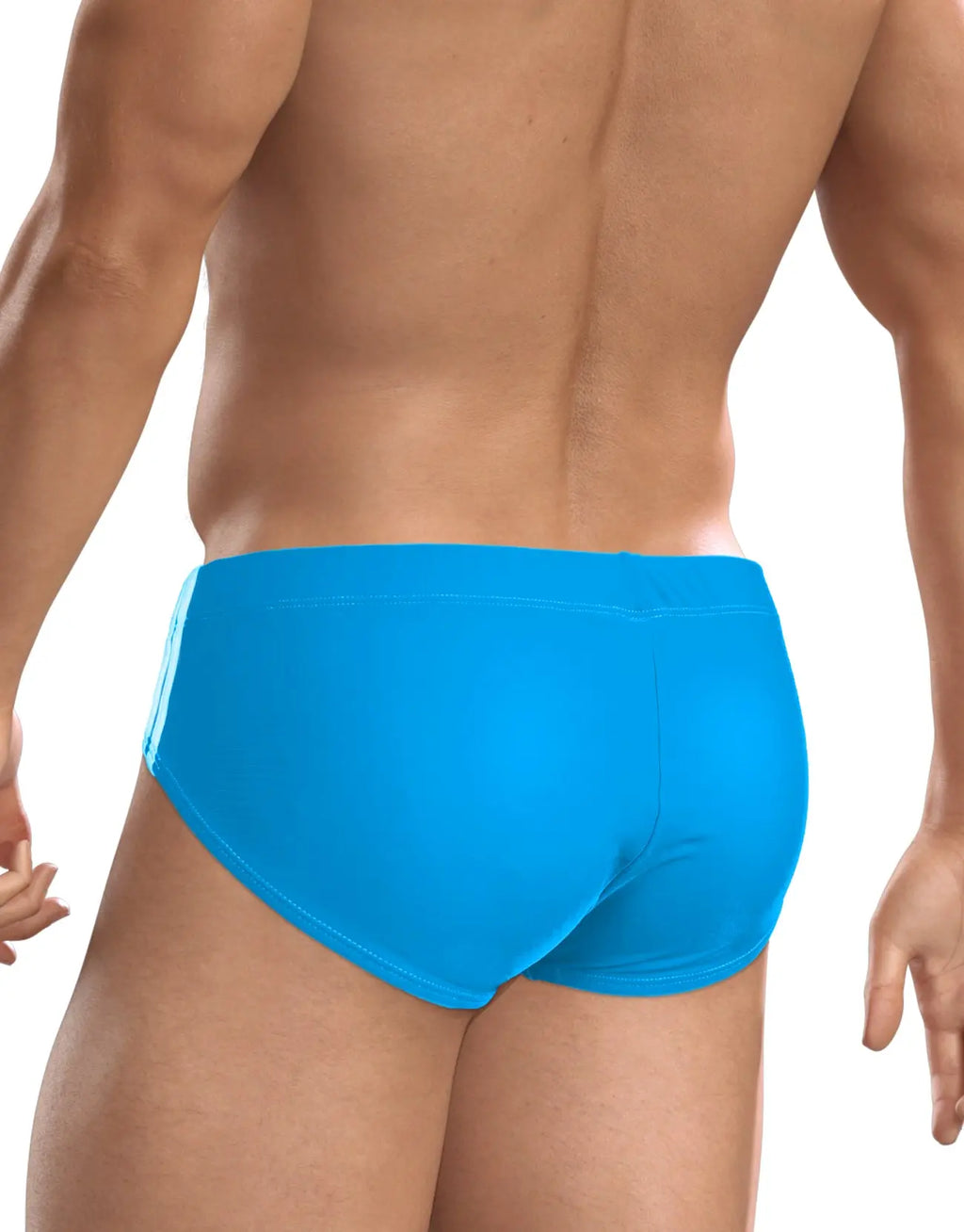 Rear view of a person wearing bright blue briefs against a white background.