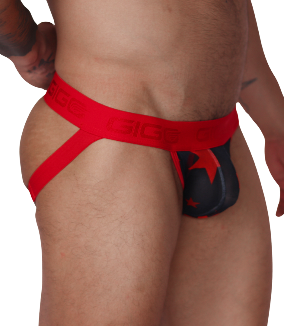 Side view of a Gigo red and black star-print jockstrap with branded elastic waistband and soft fabric pouch.