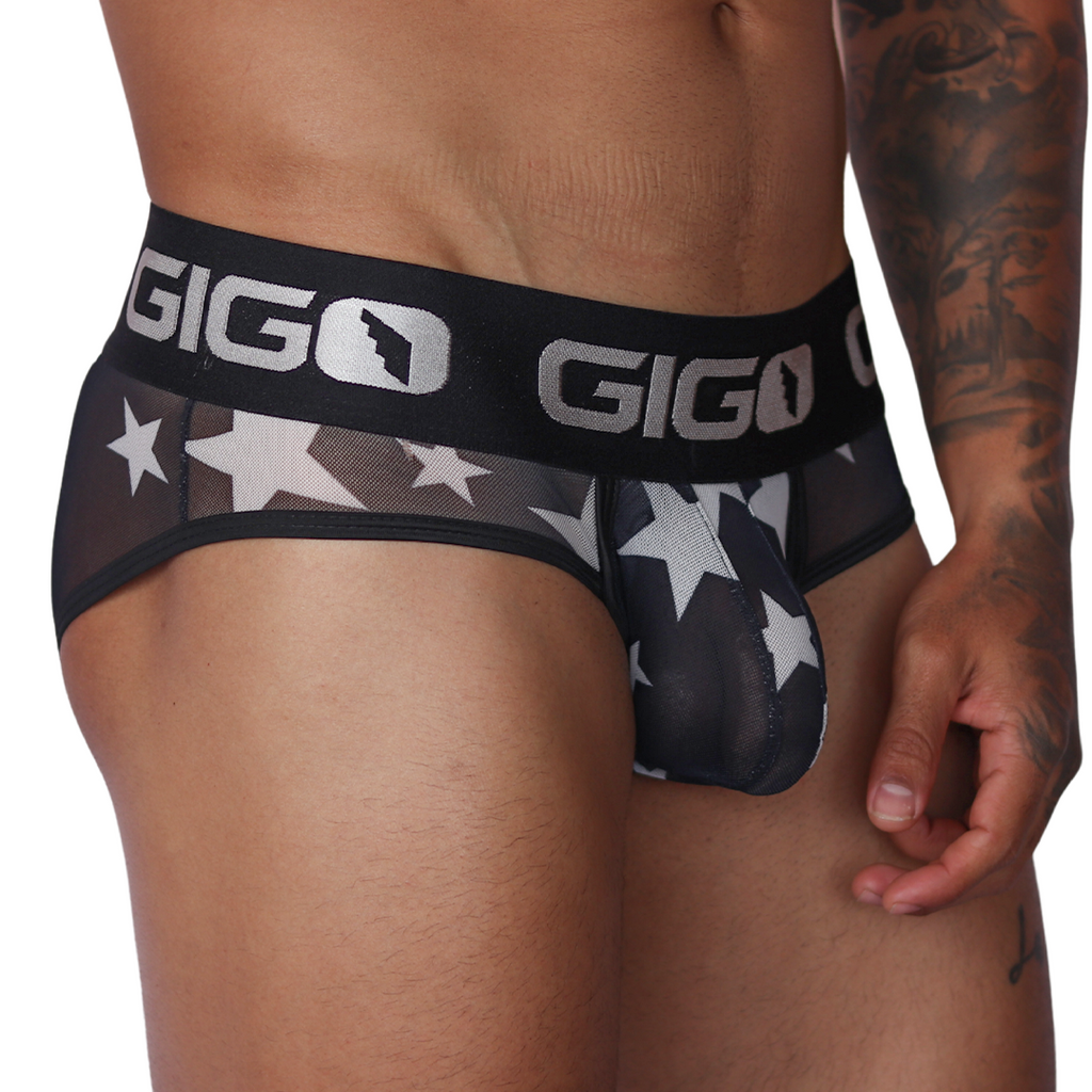 Side view of Gigo Star white brief in sheer mesh fabric with black waistband and silver star print.
