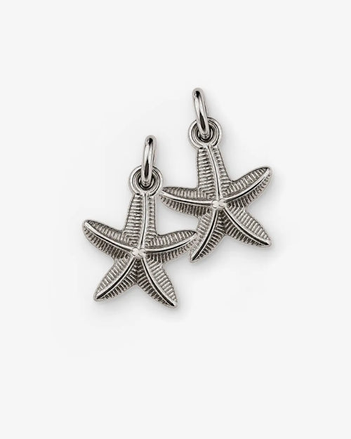 Two textured silver-tone starfish charms with oval loops on a white background.