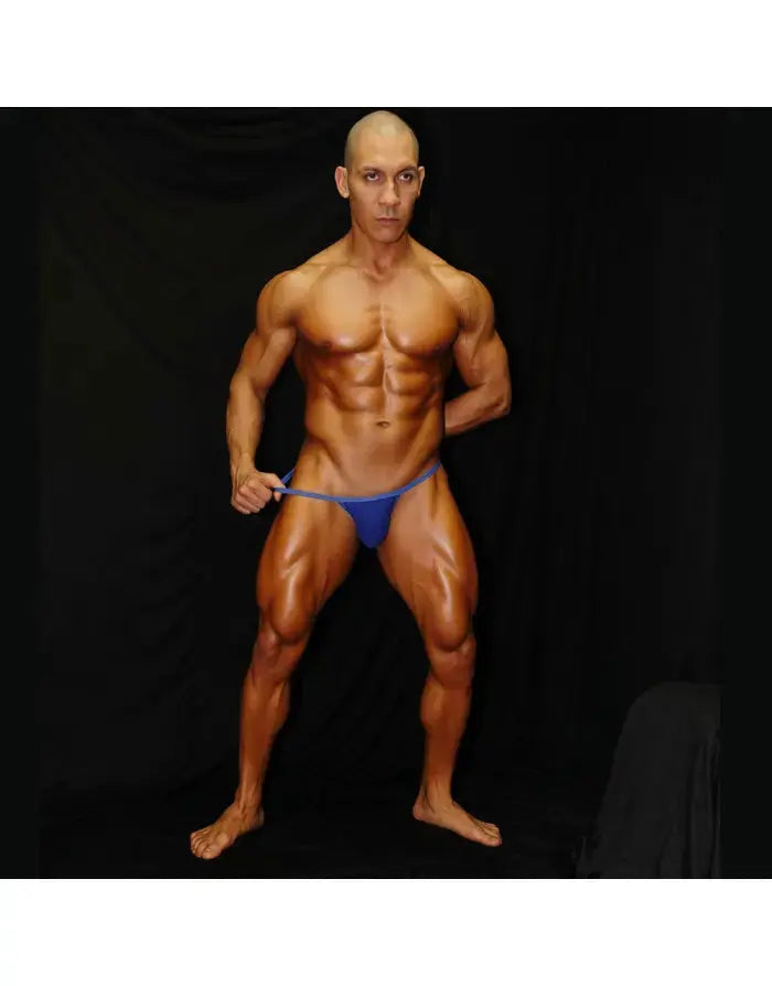 Blue thong underwear by Arroyman featuring a minimal design worn by a muscular male model against a dark background.