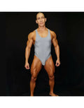 Grey ribbed bodysuit with thong cut showcasing a muscular model by Arroyman.