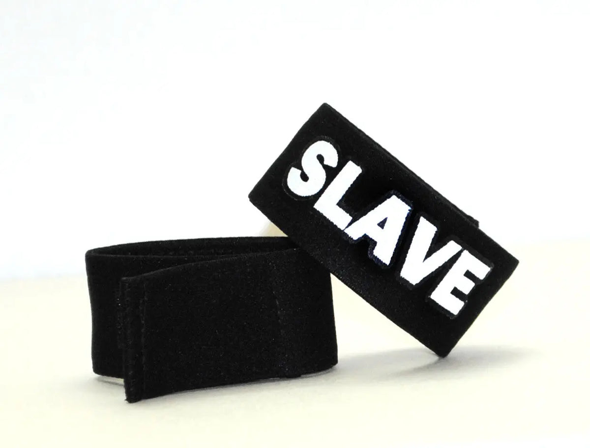 Two black bands on a white surface; one has white text reading "SLAVE".