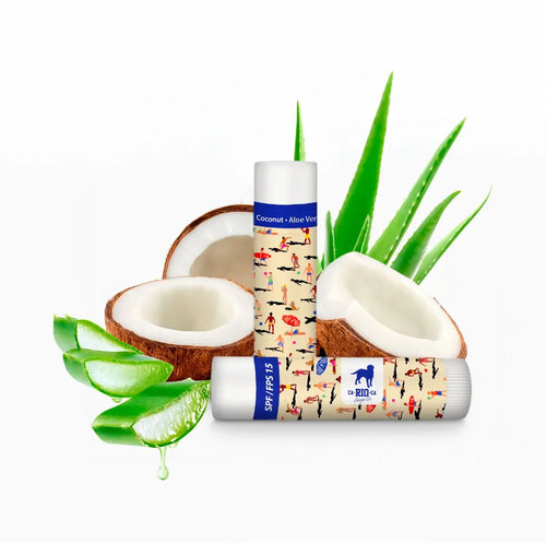 Two small labeled bottles displayed with coconut halves and green aloe leaves.