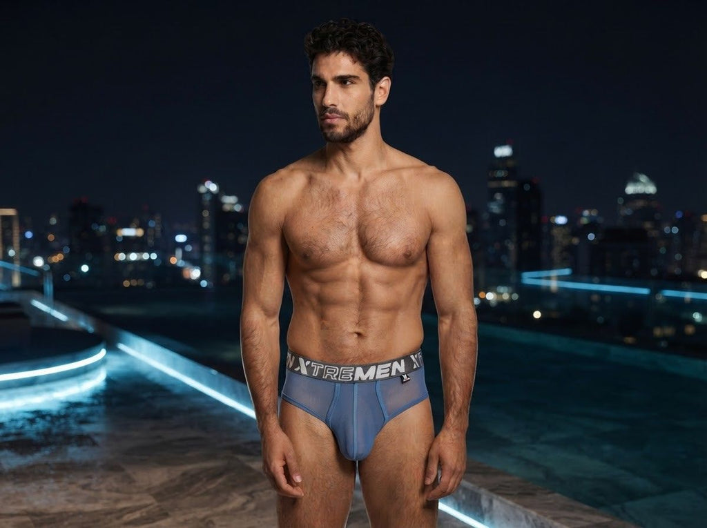 Xtremen blue mesh brief with branded elastic waistband, worn by a model at night.