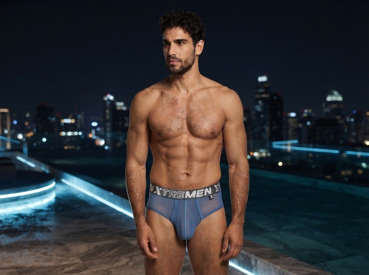 Xtremen blue mesh brief with branded elastic waistband, worn by a model at night.