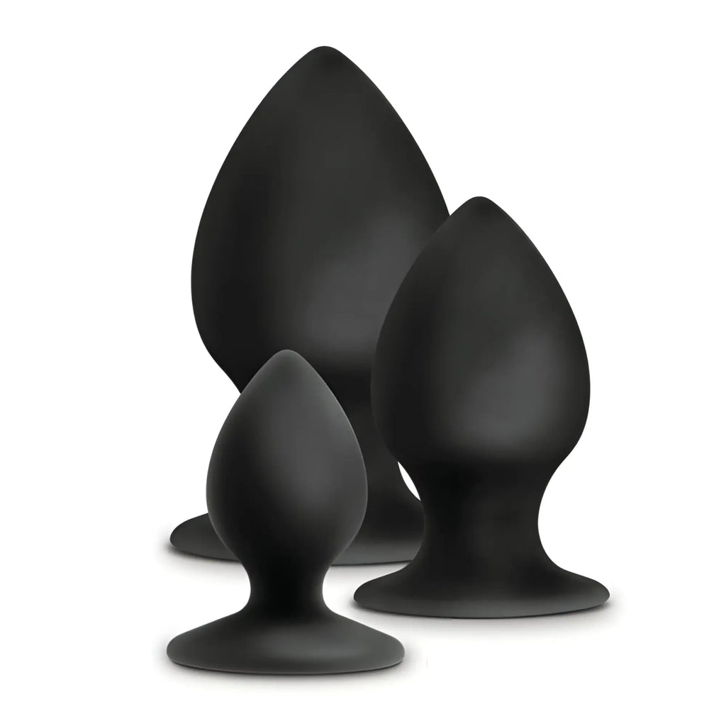 Set of three black silicone anal stout plugs in varying sizes with smooth teardrop shapes and rounded bases from Anal Adventures