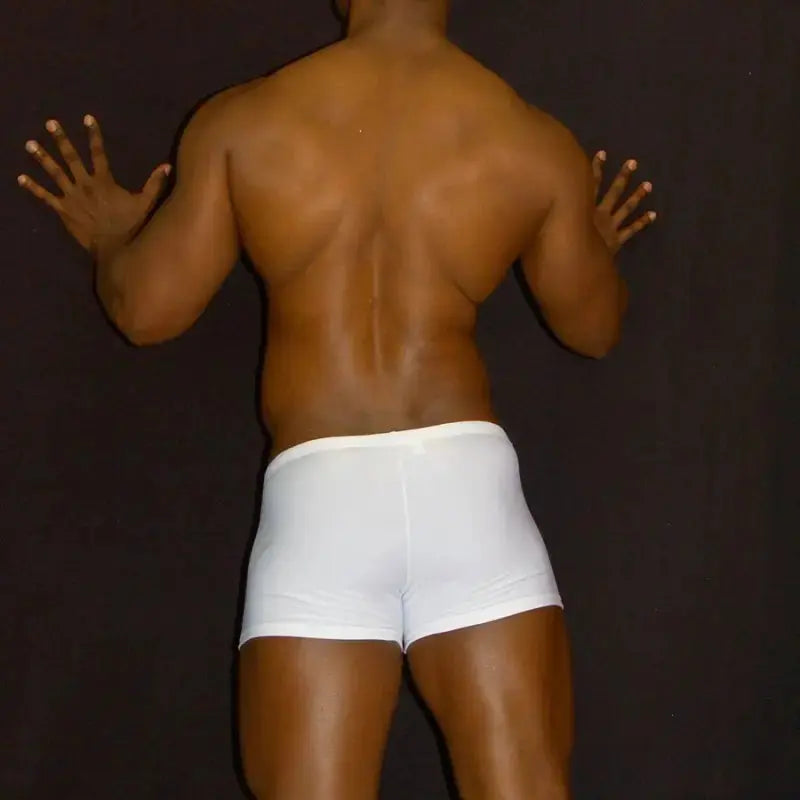 White squarecut swim boxer shorts by Arroyman featuring a snug fit and smooth fabric shown on a model from the back.