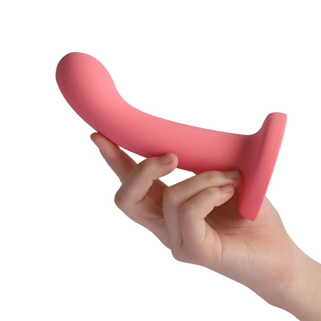 Pink silicone anal plug with flared base from arosum flexdong vibrating strap-on dildo shown from the back side
