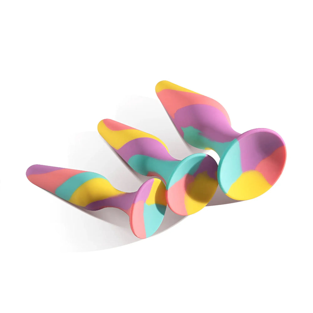 Set of three colorful silicone anal plugs with vibrant rainbow pattern from arosum tripulgs anal training kit