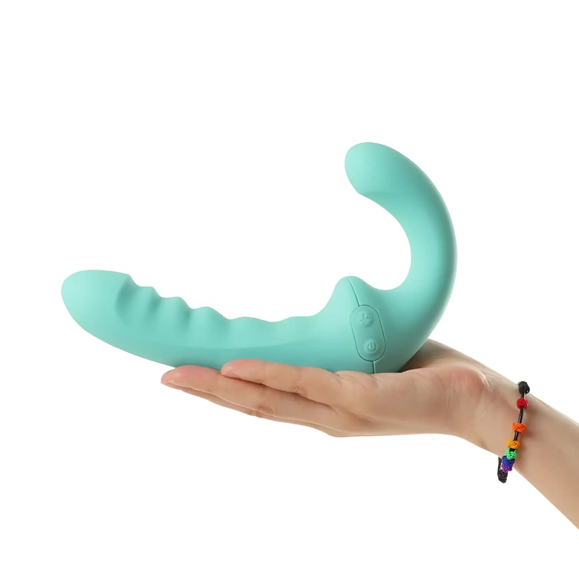 A teal silicone arosum vibratwin rechargeable come hither strapless strap on with curved ergonomic design and ridges