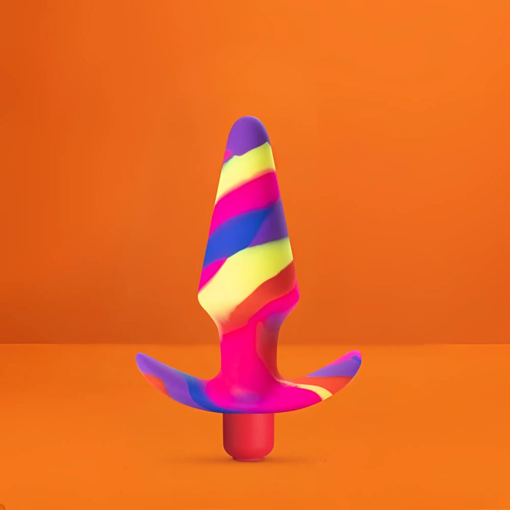 Avant Avant Free Spirit Scarlet silicone butt plug with vibrant rainbow stripes, wide base, and tapered tip