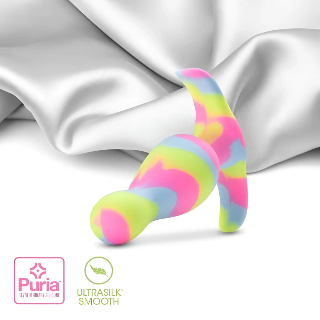 A vibrant rainbow-colored silicone butt plug with a smooth glossy finish and curved design by Avant Avant Kaleido Lime