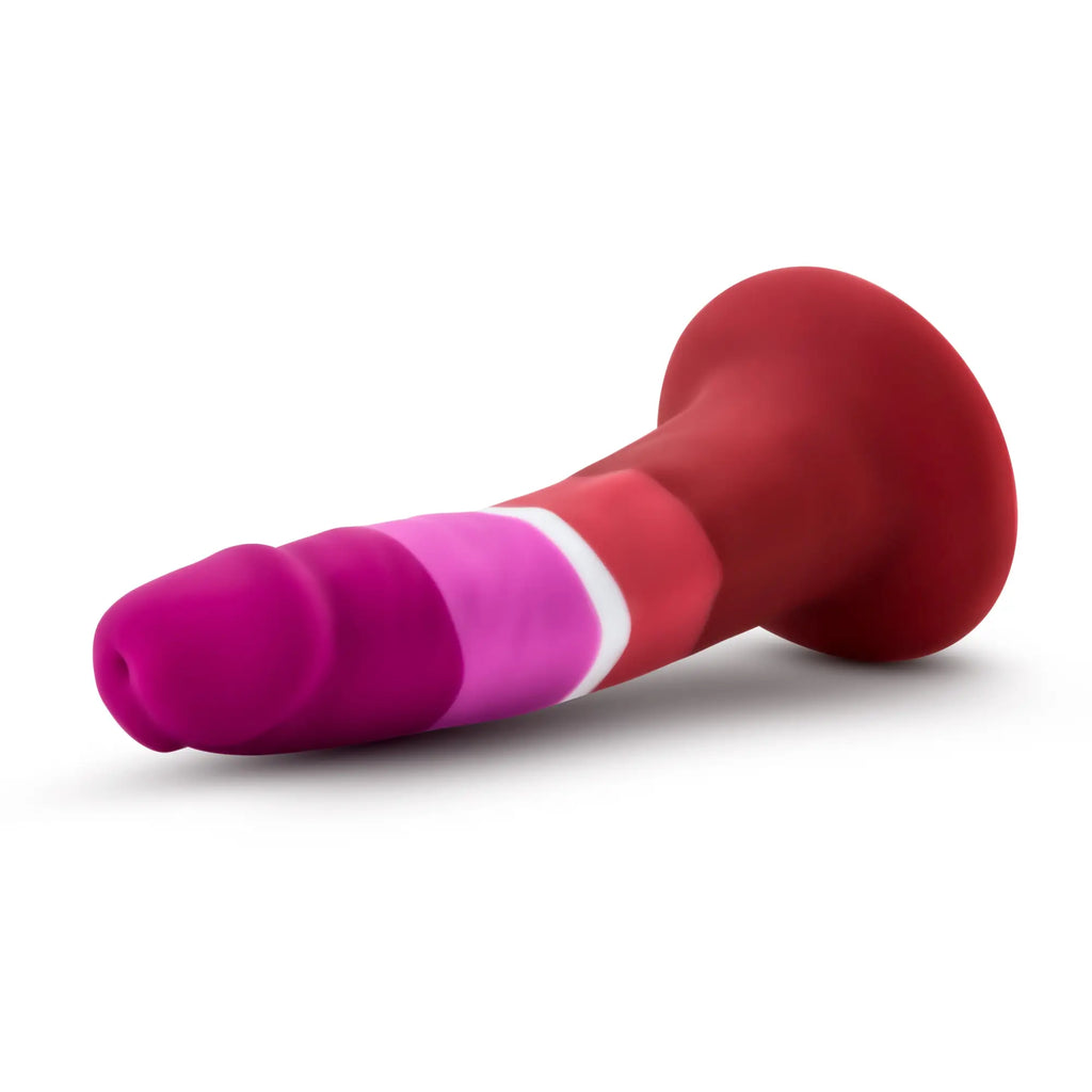 A vibrant pink and red silicone Avant Avant Pride P3 beauty dildo with a white stripe and rounded tapered tip