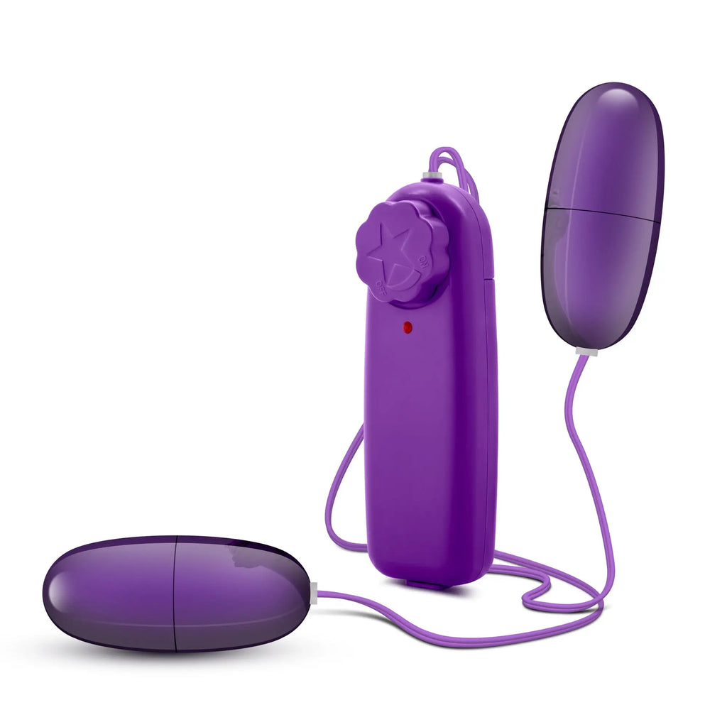 Purple silicone egg-shaped vibrator with matching purple remote control and flower button from b yours double pop eggs plum