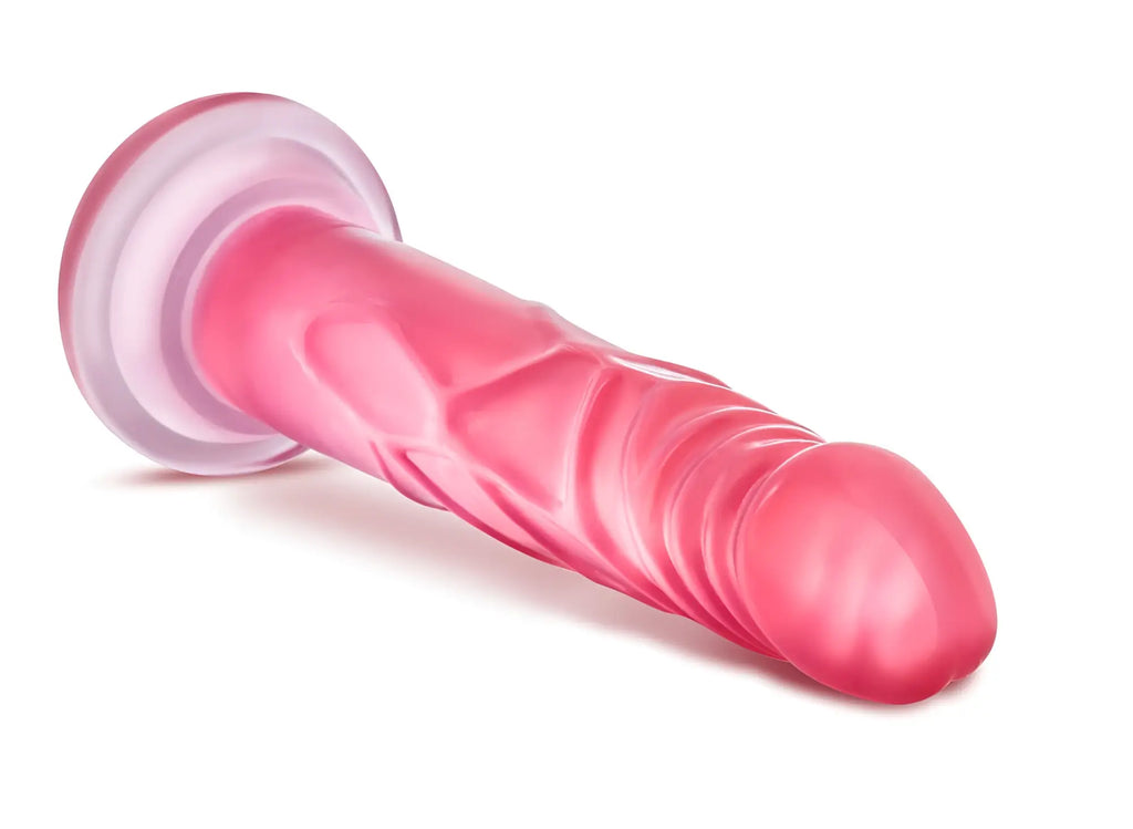 Pink translucent silicone dildo by b yours with a textured ribbed surface and rounded head for enhanced pleasure