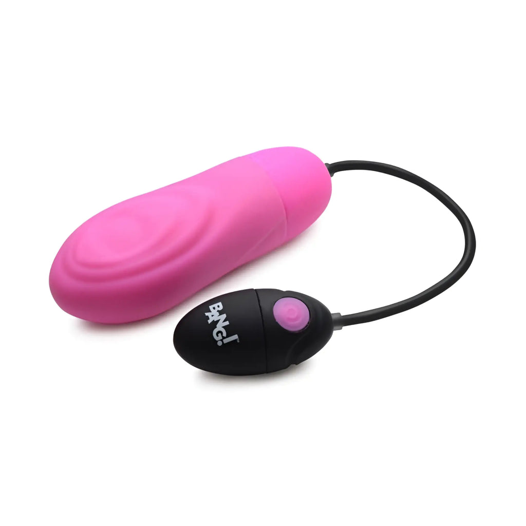 Pink silicone vibrating egg with black remote control branded ikiss featuring a purple button for pulsing stimulation