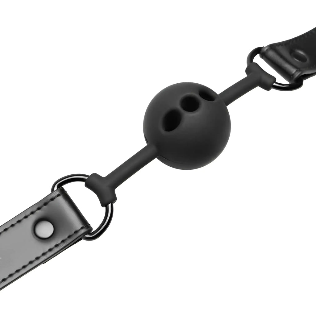 Black silicone ball gag with matte finish attached to black leather strap by metal rings from bedroom fantasies