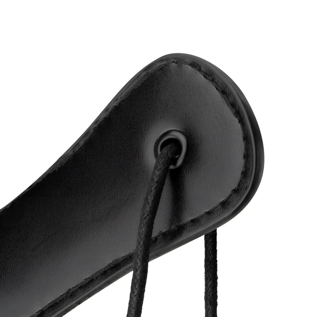 Black faux leather bedroom fantasies paddle with stitched edge and hole for black cord strap