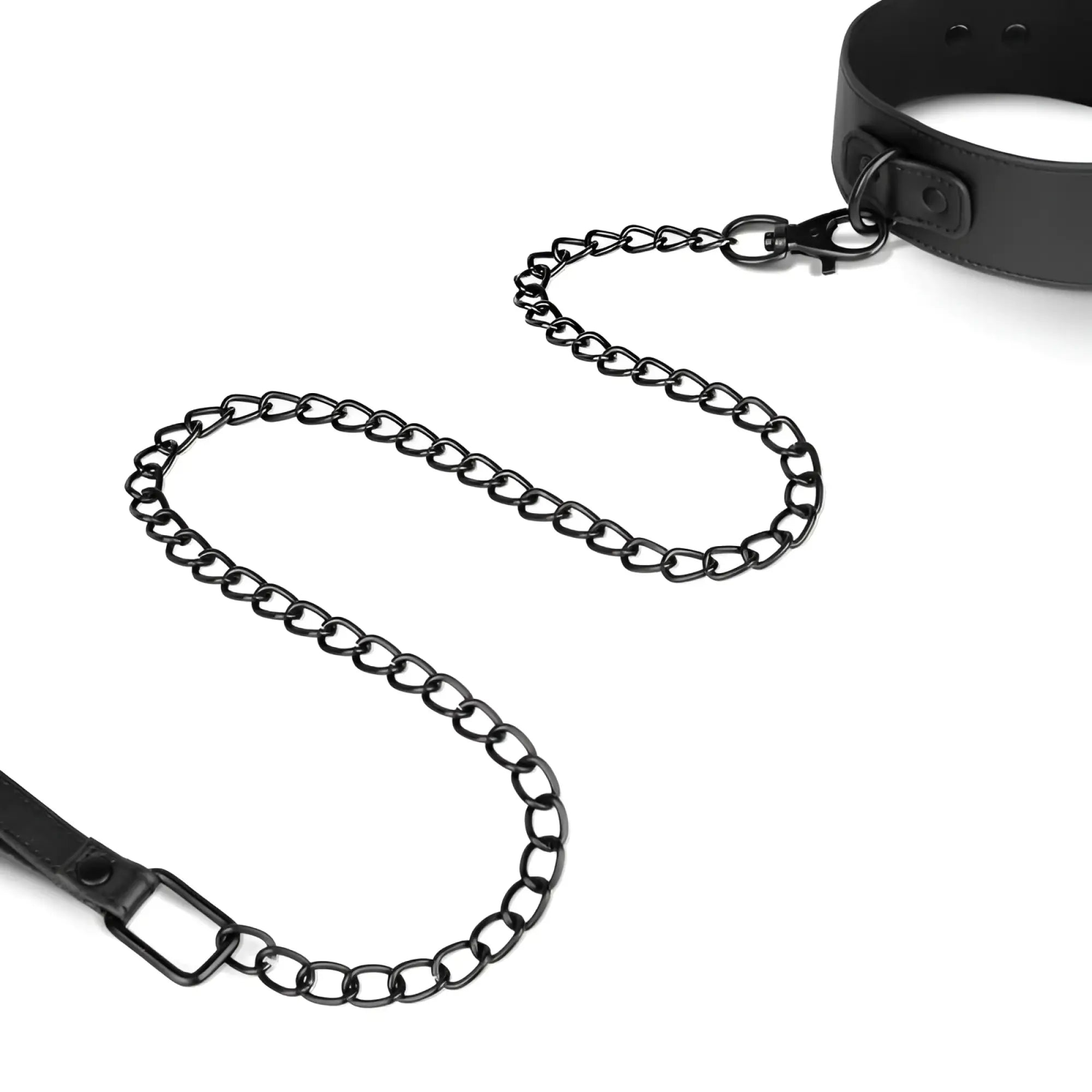 Black metal chain with matte finish connecting black leather collar and leash ends in bedroom fantasies total restraint set