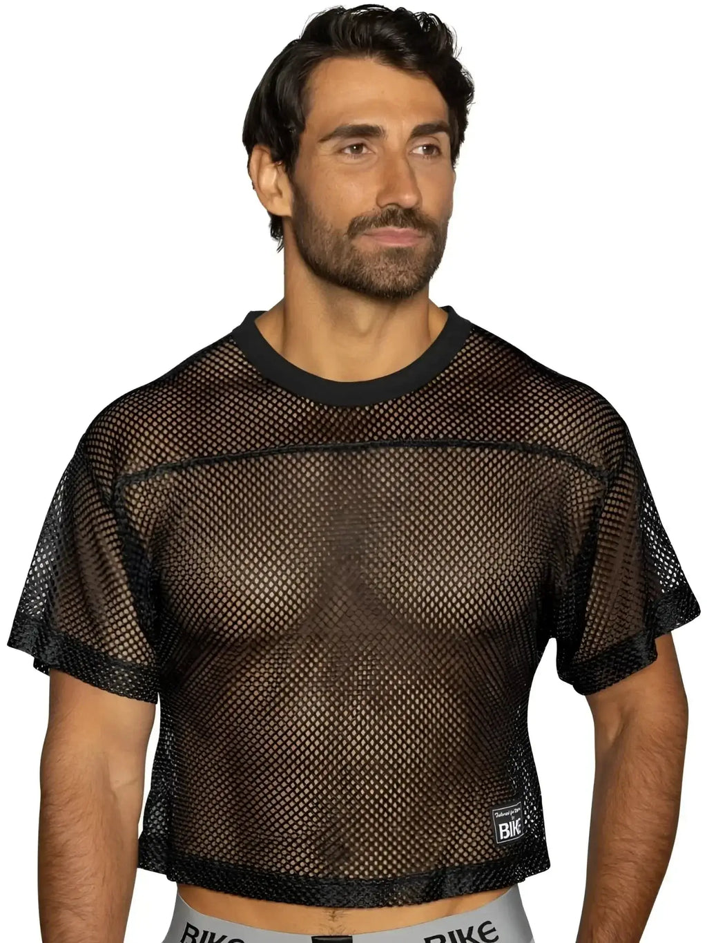 BIKE Athletic BAM134 short sleeve practice jersey in black. Studio front view of model wearing mesh top.