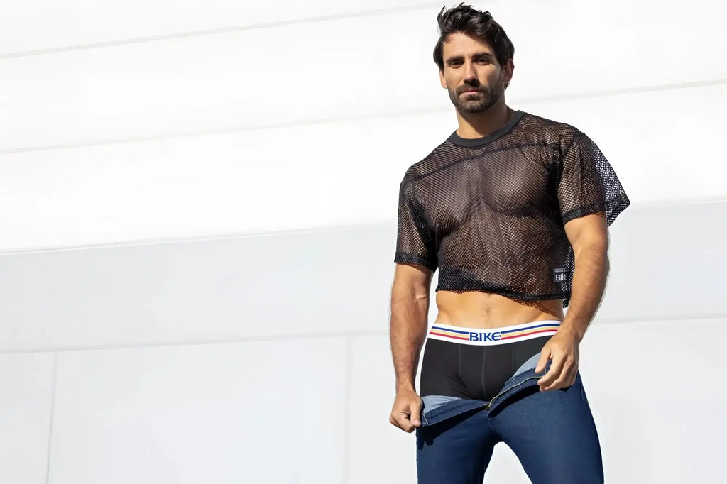 BIKE Athletic BAM134 short sleeve practice jersey in black: model wearing the mesh top in a lifestyle shot.