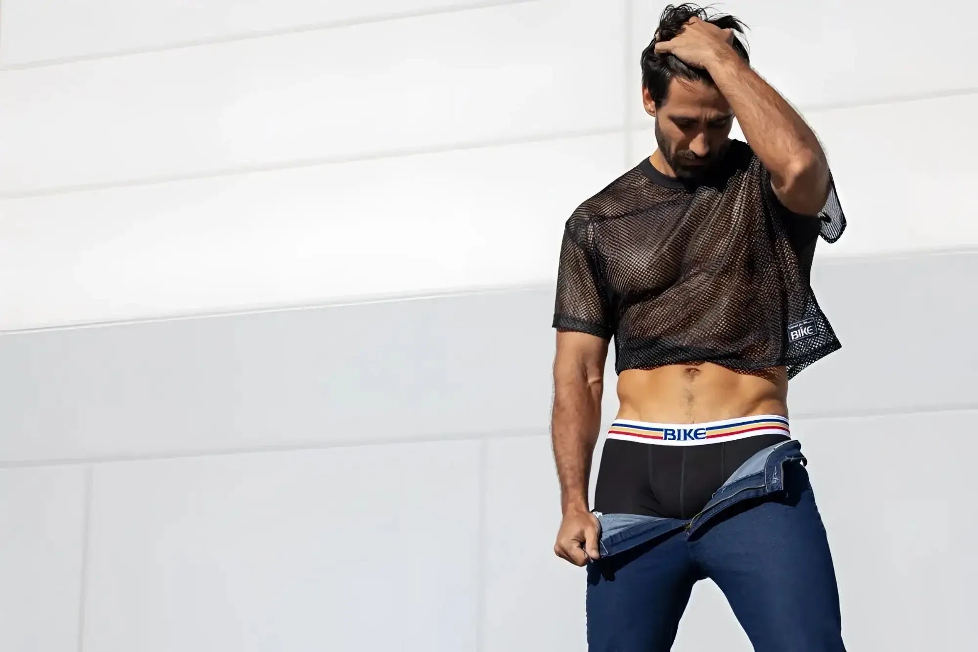 Lifestyle shot of a man wearing the black BIKE Athletic BAM134 short sleeve mesh practice jersey.
