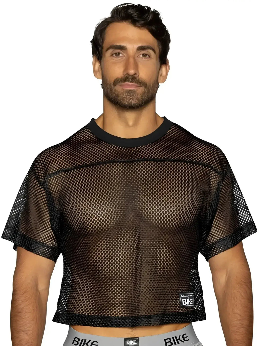 Front view of a man wearing a black BIKE Athletic BAM134 short sleeve mesh practice jersey.