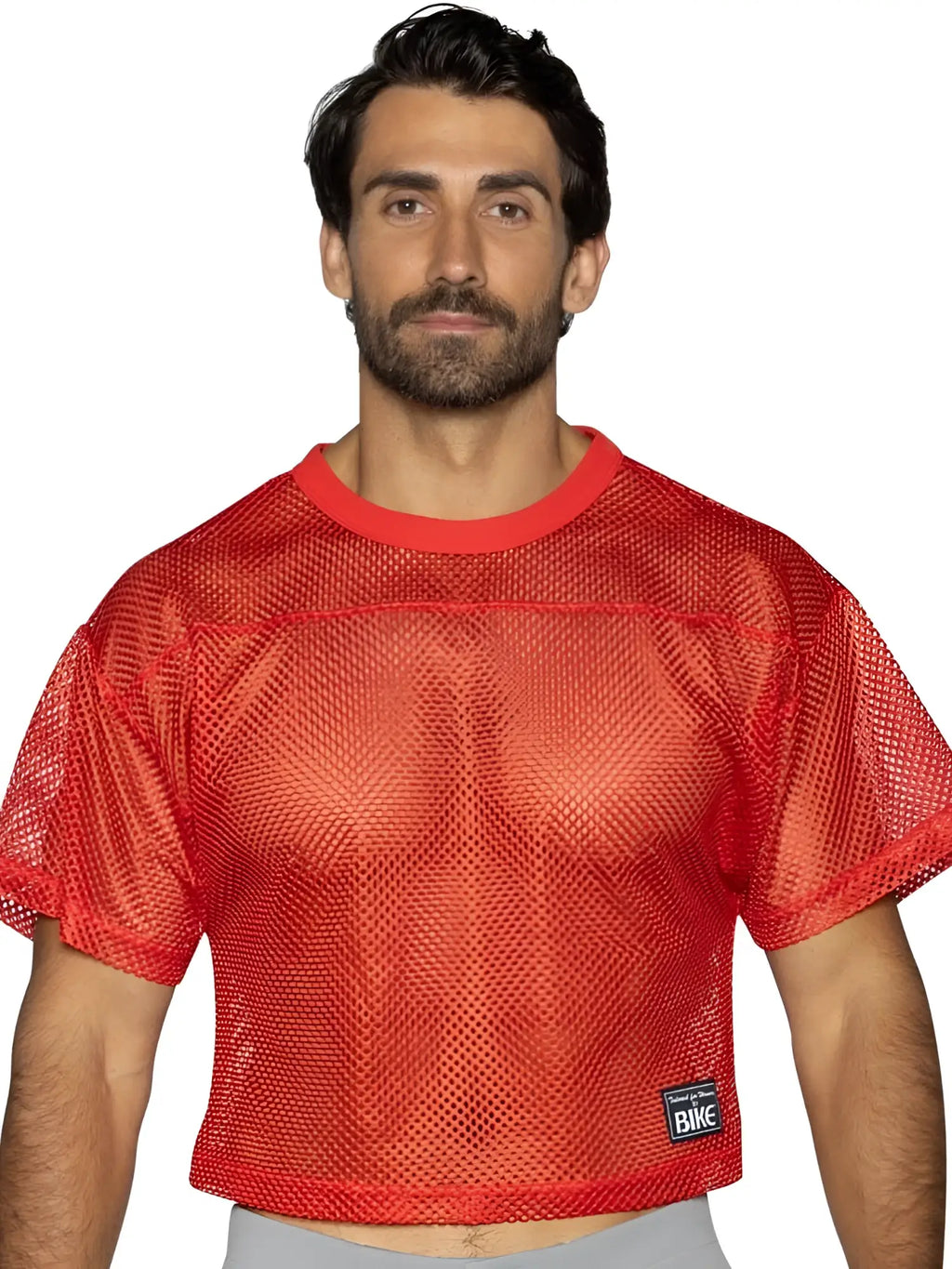 Front view of the BIKE Athletic BAM134 short sleeve practice jersey in bright red on a model.