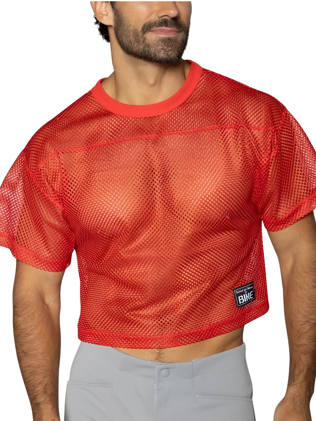 Front view of a model wearing a BIKE Athletic BAM134 short sleeve mesh practice jersey in bright red.