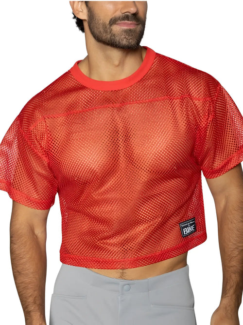 Front view of a model wearing a BIKE Athletic BAM134 short sleeve mesh practice jersey in bright red.