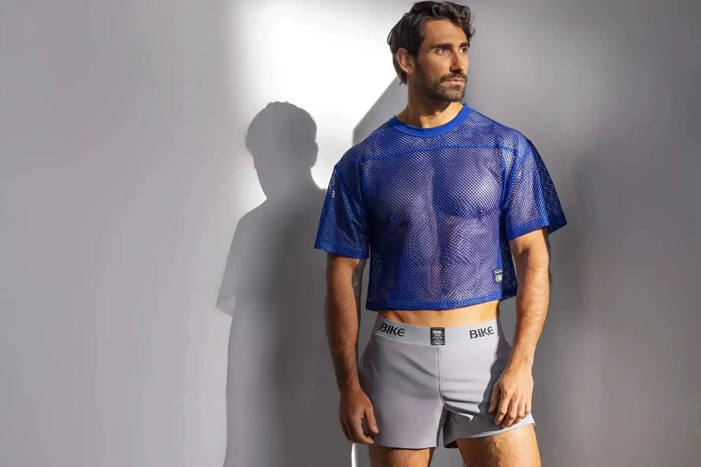 Lifestyle shot of a man wearing the BIKE Athletic BAM134 short sleeve practice jersey in royal blue.