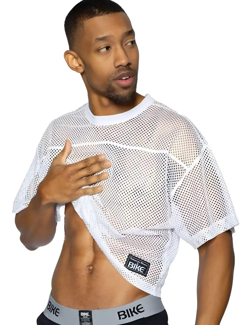 BIKE Athletic BAM134 short sleeve white practice jersey. Lifestyle shot of a man wearing the mesh jersey.