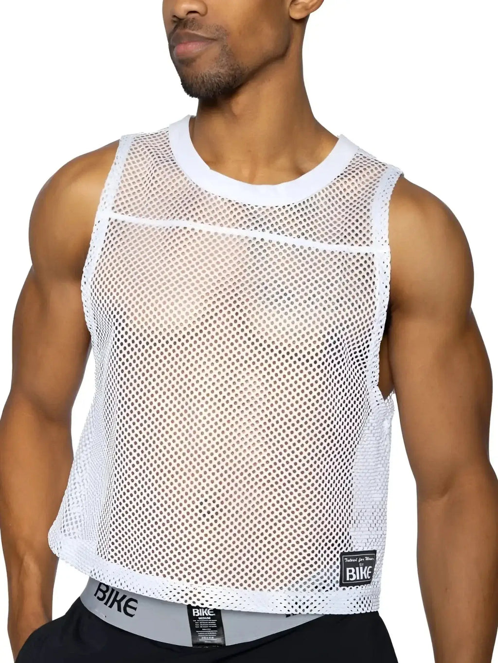 BIKE Athletic BAM135 sleeveless practice jersey in white, shown in a front-view lifestyle shot on a model.