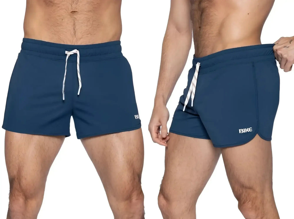 Front and side view of BIKE Athletic BAM200 track shorts in navy worn by a model.