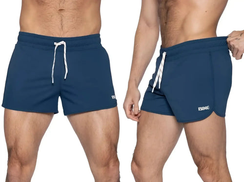 Front and side view of BIKE Athletic BAM200 track shorts in navy worn by a model.